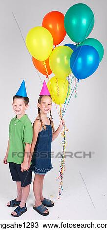 Two children holding balloons View Large Photo Image Stock Image - Two children holding balloons . Fotosearch