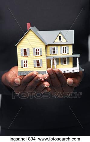Picture - Woman holding house BE 2. Fotosearch