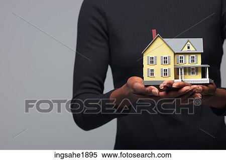 Woman holding house BE 4 View Large Photo Image Stock Photography - Woman holding house BE 4. Fotosearch