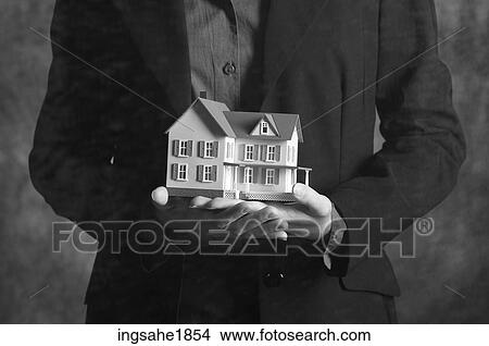 Woman holding model house BE 3 View Large Photo Image Picture - Woman holding model house BE 3. Fotosearch