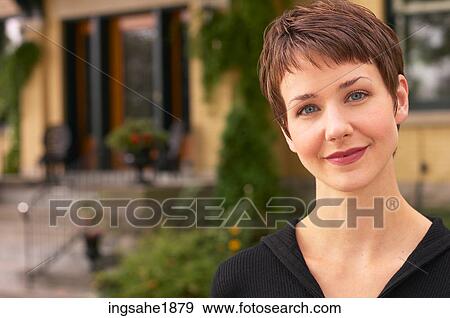 Woman in front of house BE 3 View Large Photo Image Stock Photo - Woman in front of house BE 3. Fotosearch