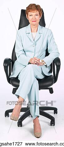 Stock Photo - Woman Sitting in Chair BE 5. Fotosearch
