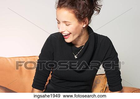 Woman sitting on couch BE 10 View Large Photo Image Stock Photo - Woman sitting on couch BE 10. Fotosearch