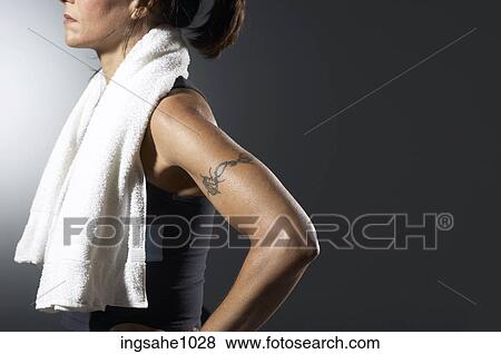 Woman with tattooed arm View Large Photo Image Stock Photo - Woman with tattooed arm . Fotosearch