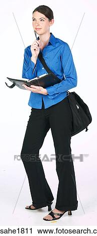 Stock Image - woman writing in planner BE 3. Fotosearch
