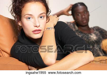 Stock Photography - Women sitting on chair BE. Fotosearch