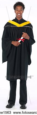 Stock Image - young man wearing graduation gown . Fotosearch