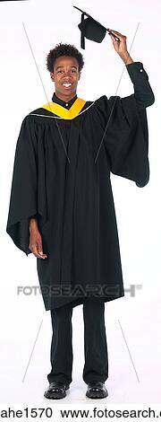 Stock Image - young man wearing graduation gown . Fotosearch