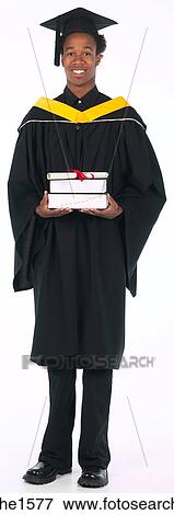 Stock Photo - young man wearing graduation gown . Fotosearch