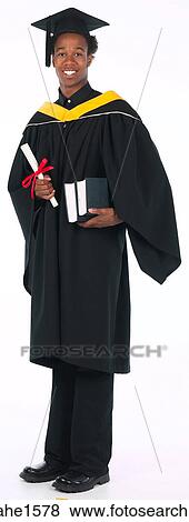 Stock Photo - young man wearing graduation gown . Fotosearch