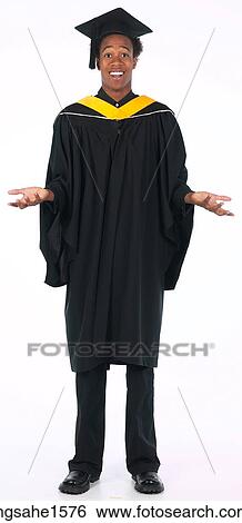 Stock Photograph - young man wearing graduation gown . Fotosearch
