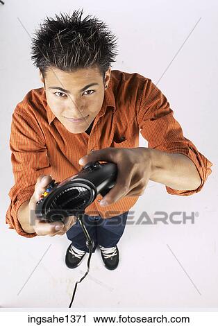 Stock Image - young man with orange shirt . Fotosearch