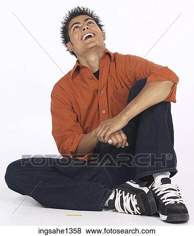 Stock Photo - young man with orange shirt . Fotosearch