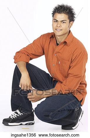 Stock Photograph - young man with orange shirt . Fotosearch