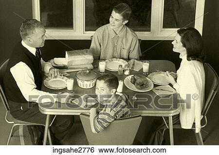 Stock Photograph - 1950s family at dinner table . Fotosearch