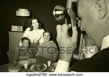 Stock Image - 1950s family taking picture . Fotosearch