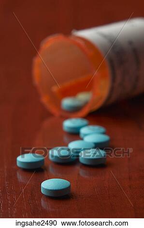 Stock Image - Bottle of blue pills. Fotosearch