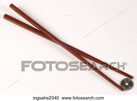 Stock Image - Chopsticks holding coin. Fotosearch