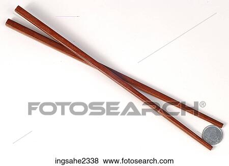 Stock Photo - Chopsticks holding coin . Fotosearch