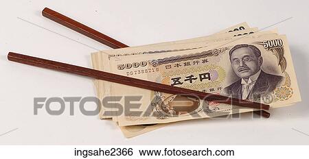 Chopsticks holding money View Large Photo Image Stock Photograph - Chopsticks holding money. Fotosearch