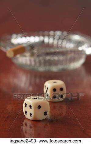 Cigarette in ashtray and pair of dice View Large Photo Image Stock Image - Cigarette in ashtray and pair of dice. Fotosearch