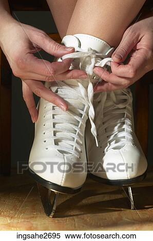 Close-up of woman lacing up skates View Large Photo Image Stock Photography - Close-up of woman lacing up skates . Fotosearch