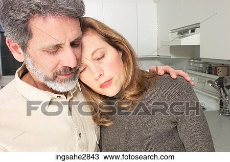 Couple leaning on each other in kitchen View Large Photo Image Stock Image - Couple leaning on each other in kitchen . Fotosearch