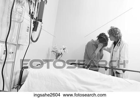 Doctor comforting patient's mother View Large Photo Image Picture - Doctor comforting patient's mother . Fotosearch