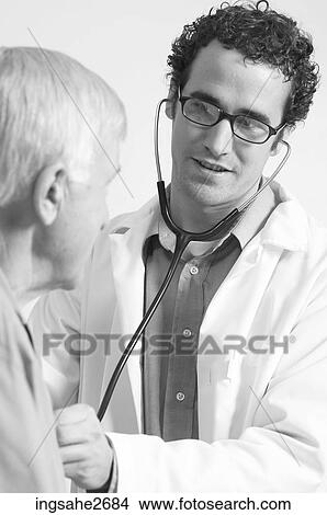 Picture - Doctor examining elderly patient . Fotosearch