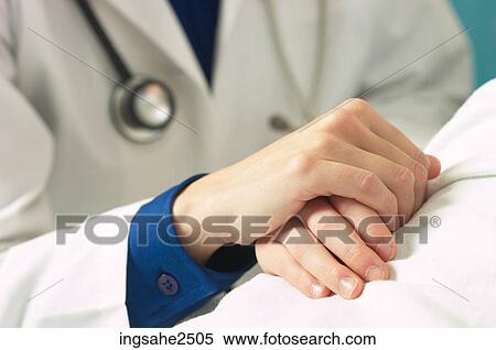 Stock Photography - Doctor holding patient's hand an 3. Fotosearch