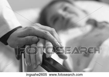 Doctor holding patient's hand View Large Photo Image Stock Photography - Doctor holding patient's hand. Fotosearch