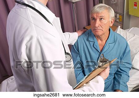 Stock Image - Doctor with elderly patient . Fotosearch