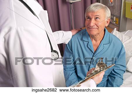 Stock Image - Doctor with elderly patient . Fotosearch