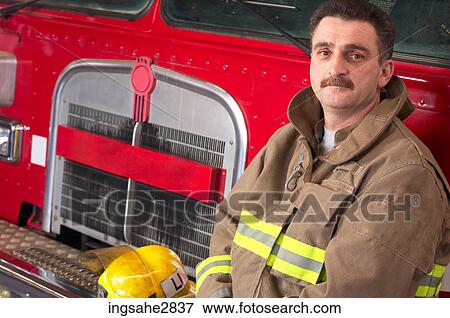 Fireman in front of firetruck View Large Photo Image Stock Photo - Fireman in front of firetruck . Fotosearch