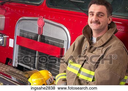 Fireman in front of firetruck View Large Photo Image Stock Photo - Fireman in front of firetruck . Fotosearch