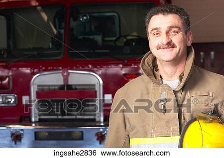 Fireman in front of firetruck View Large Photo Image Stock Photograph - Fireman in front of firetruck . Fotosearch