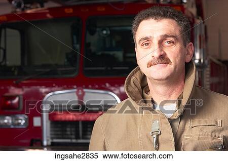 Fireman in front of firetruck View Large Photo Image Stock Photography - Fireman in front of firetruck . Fotosearch