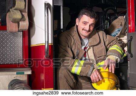 Fireman sitting in firetruck View Large Photo Image Stock Photo - Fireman sitting in firetruck . Fotosearch