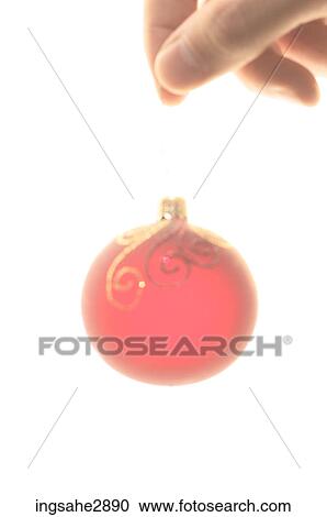Hand holding red Christmas ornament View Large Photo Image Stock Image - Hand holding red Christmas ornament . Fotosearch