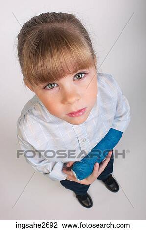 Stock Image - Little girl cradling broken arm . Fotosearch