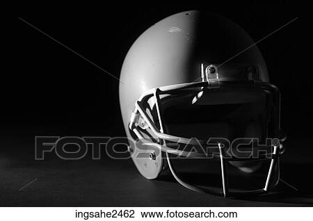 Stock Image - Lone football helmet with shadow . Fotosearch