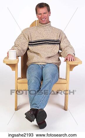 Man in wooden chair enjoying coffee View Large Photo Image Stock Image - Man in wooden chair enjoying coffee . Fotosearch