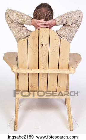 Man in wooden lounge chair View Large Photo Image Stock Photo - Man in wooden lounge chair . Fotosearch