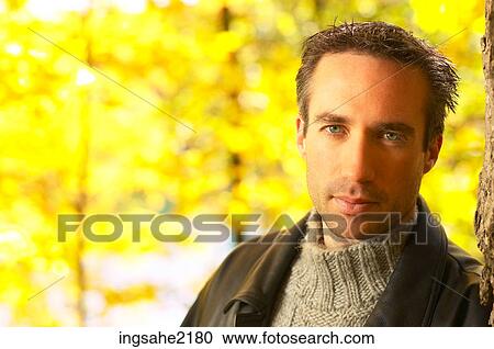 Man leaning against tree a81 View Large Photo Image Stock Image - Man leaning against tree a81. Fotosearch
