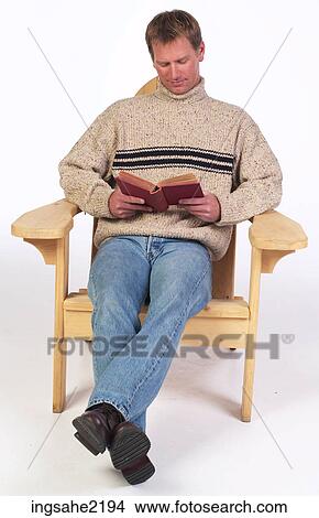 Man reading book in wooden lounge chair View Large Photo Image Picture - Man reading book in wooden lounge chair . Fotosearch