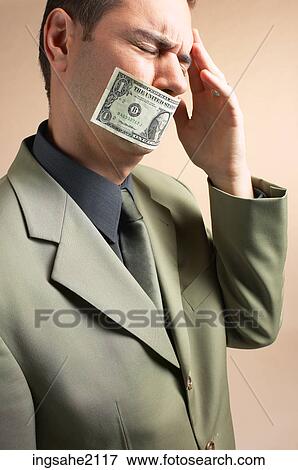 man with money over mouth BE 5 View Large Photo Image Stock Photo - man with money over mouth BE 5. Fotosearch