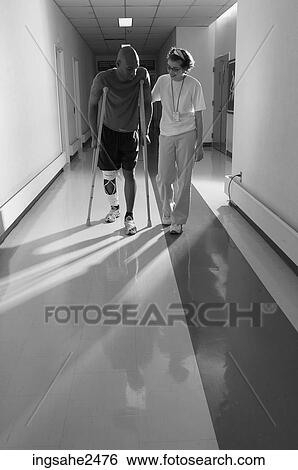 Patient walking down hallway on crutches with nurse an 1 View Large Photo Image Stock Photograph - Patient walking down hallway on crutches with nurse an 1. Fotosearch