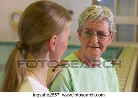 Stock Photo - Patient with physiotherapist by pool an 7. Fotosearch