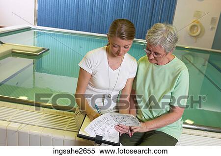 Patient with physiotherapist by pool an 4 View Large Photo Image Stock Photography - Patient with physiotherapist by pool an 4. Fotosearch