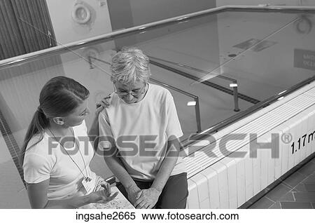 Patient with physiotherapist by pool View Large Photo Image Stock Photography - Patient with physiotherapist by pool. Fotosearch